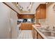 Spacious kitchen featuring updated appliances, oak cabinets, and tiled floors at 775 Cathy Ln, Henderson, NV 89015