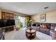 Inviting living room features a large leather sofa, built-in shelving, and sliding glass doors to the outside at 775 Cathy Ln, Henderson, NV 89015