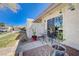 Charming patio area with outdoor seating, enhanced by lush greenery and manicured landscaping at 775 Cathy Ln, Henderson, NV 89015