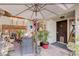 Inviting outdoor patio area with comfortable seating and a large umbrella for shade at 775 Cathy Ln, Henderson, NV 89015