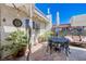 Outdoor patio with a dining table, seating area, and decorative plants at 775 Cathy Ln, Henderson, NV 89015