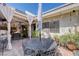 Outdoor patio with a dining table, seating area, and shaded pergola at 775 Cathy Ln, Henderson, NV 89015