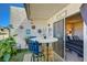 Inviting patio area with outdoor seating and decor, seamlessly connecting to the cozy bedroom through sliding glass doors at 775 Cathy Ln, Henderson, NV 89015