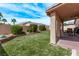 Lush backyard featuring manicured lawn, mature trees, and covered patio area for outdoor living at 803 Fetter Ct, Henderson, NV 89052