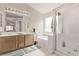 A bathroom featuring double sinks, a glass shower, and a separate soaking tub at 803 Fetter Ct, Henderson, NV 89052