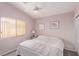 Bright bedroom with a ceiling fan, light-colored walls, and a window letting in natural light at 803 Fetter Ct, Henderson, NV 89052