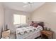 Cozy bedroom featuring a ceiling fan and a comfortable-looking bed with a patterned quilt at 803 Fetter Ct, Henderson, NV 89052