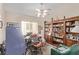Well-lit home office with a ceiling fan, built-in bookshelves, and a comfortable workspace at 803 Fetter Ct, Henderson, NV 89052