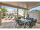 Covered back patio with outdoor seating and a well-maintained garden at 841 Rusty Anchor Way, Henderson, NV 89002