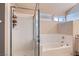 Bright bathroom featuring a separate shower and tub with large window at 841 Rusty Anchor Way, Henderson, NV 89002