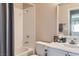 Bathroom with tub and shower combination, with white tile surround and neutral decor at 841 Rusty Anchor Way, Henderson, NV 89002