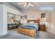 Comfortable bedroom featuring a wooden bed frame, mirrored closet, and soft carpet at 841 Rusty Anchor Way, Henderson, NV 89002