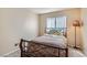 Cozy bedroom with neutral walls and carpet, showcasing a window and a bedside lamp at 841 Rusty Anchor Way, Henderson, NV 89002