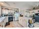 Bright kitchen with tile flooring, white cabinets and modern appliances at 841 Rusty Anchor Way, Henderson, NV 89002