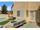 The backyard features outdoor seating and lounging areas with access to the home and pool area at 947 Rainbow Rock St, Las Vegas, NV 89123