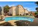 Expansive backyard featuring a swimming pool, cozy seating area, and lush landscaping, perfect for entertaining at 947 Rainbow Rock St, Las Vegas, NV 89123