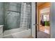 Beautifully renovated bathroom with tiled niche and modern shower curtain at 947 Rainbow Rock St, Las Vegas, NV 89123