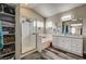 Bright bathroom features a glass enclosed shower, soaking tub and dual sink vanity with wood-look floors at 947 Rainbow Rock St, Las Vegas, NV 89123