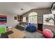 Spacious bedroom with vaulted ceiling, multiple windows, and comfortable seating area at 947 Rainbow Rock St, Las Vegas, NV 89123
