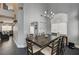 Bright dining room with rustic wood table, unique chandelier, and large window with natural light at 947 Rainbow Rock St, Las Vegas, NV 89123