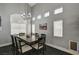 Formal dining room featuring contemporary lighting, a large table, and desert wall art at 947 Rainbow Rock St, Las Vegas, NV 89123