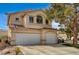 Two story home with a three-car garage, lush landscaping, and beautiful curb appeal at 947 Rainbow Rock St, Las Vegas, NV 89123