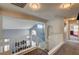 Upstairs hallway overlooking stairs features neutral colors, leading to multiple rooms at 947 Rainbow Rock St, Las Vegas, NV 89123