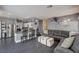 Open concept living area with modern kitchen island and spacious gray sectional sofa at 947 Rainbow Rock St, Las Vegas, NV 89123