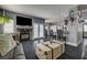 Open-concept living room with a fireplace, access to the backyard and a kitchen breakfast bar at 947 Rainbow Rock St, Las Vegas, NV 89123