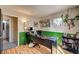 Office space features wood floors, green paneled accent wall, and a large desk for working from home at 947 Rainbow Rock St, Las Vegas, NV 89123