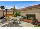 Charming outdoor patio with table, chairs, and decorative garden features; ideal for outdoor dining and relaxation at 947 Rainbow Rock St, Las Vegas, NV 89123