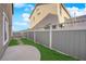 Well-maintained backyard with a concrete patio, lush grass, and a privacy fence at 963 Sable Chase Pl, Henderson, NV 89011