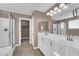 Bathroom boasts double sinks, modern fixtures, large mirror, and walk-in shower at 963 Sable Chase Pl, Henderson, NV 89011