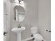 Powder room features pedestal sink, toilet, and updated lighting at 963 Sable Chase Pl, Henderson, NV 89011