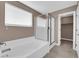 Stylish bathroom featuring a large soaking tub, a separate glass shower, and neutral decor at 963 Sable Chase Pl, Henderson, NV 89011