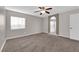 Spacious bedroom features neutral tones, a ceiling fan, and an arched entryway to the bathroom at 963 Sable Chase Pl, Henderson, NV 89011