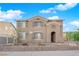 Charming two-story home with tan stucco, low brick wall and an arched entry at 963 Sable Chase Pl, Henderson, NV 89011