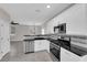 Open kitchen boasts stainless steel appliances, granite countertops, and modern lighting at 963 Sable Chase Pl, Henderson, NV 89011