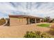 Exterior view of home with a covered patio and landscaped backyard with gravel and turf at 9731 Addie Meadow Ct, Las Vegas, NV 89149
