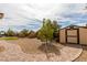 Spacious backyard featuring a shed, lush landscaping, and a charming brick pathway at 9731 Addie Meadow Ct, Las Vegas, NV 89149