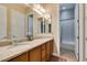 Bathroom featuring double sinks, granite countertops, and a separate shower and bathtub at 9731 Addie Meadow Ct, Las Vegas, NV 89149