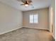 Bright, carpeted bedroom with a ceiling fan and a large window offering natural light at 9731 Addie Meadow Ct, Las Vegas, NV 89149