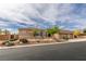 View of the front of a single-story home with a three-car garage and desert landscaping at 9731 Addie Meadow Ct, Las Vegas, NV 89149