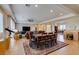 Bright open-concept living and dining area features tile floors, large windows, and comfortable furnishings at 9731 Addie Meadow Ct, Las Vegas, NV 89149