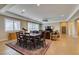 Spacious living area with tile flooring, ample seating, a ceiling fan, and natural light from large windows at 9731 Addie Meadow Ct, Las Vegas, NV 89149