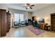 Office space with neutral walls, plantation shutters, a ceiling fan, and custom built-in shelving at 9731 Addie Meadow Ct, Las Vegas, NV 89149