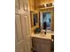 Bathroom with a sink, vanity, and a view into another room, showcasing a practical layout at 976 Dancing Vines Ave, Las Vegas, NV 89183
