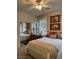 Comfortable bedroom with a plush bed, mirrored closet, and bright natural light at 976 Dancing Vines Ave, Las Vegas, NV 89183