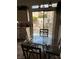 Bright dining area featuring a glass-top table and sliding door access to the outdoor patio at 976 Dancing Vines Ave, Las Vegas, NV 89183
