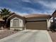 Inviting single-story home featuring a two-car garage, desert landscaping and a terracotta tile roof at 976 Dancing Vines Ave, Las Vegas, NV 89183